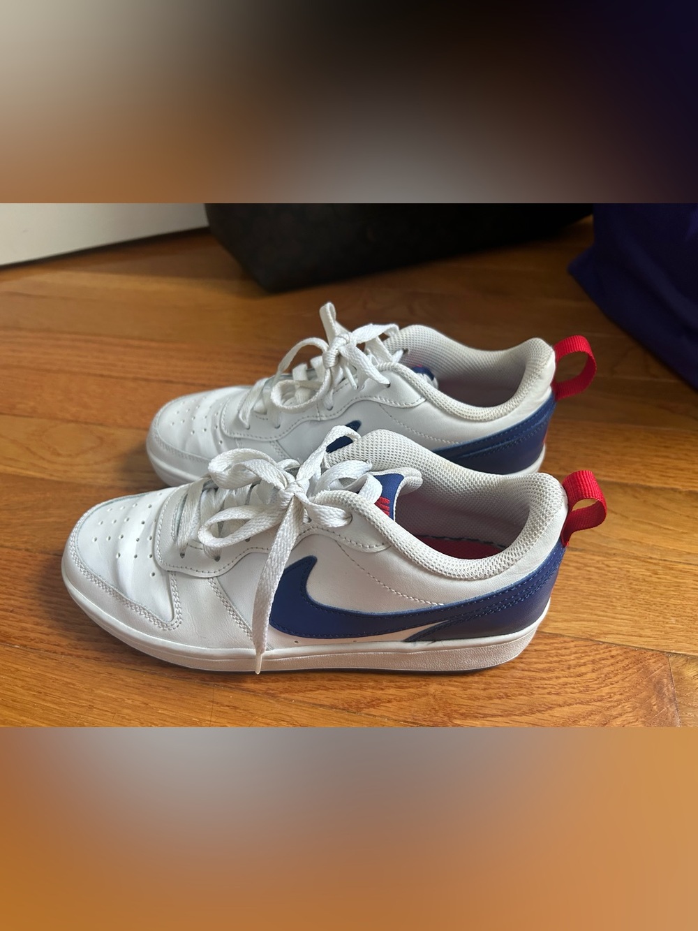 Nike Kids White Sneakers with Blue Swoosh and Red Heel Tab